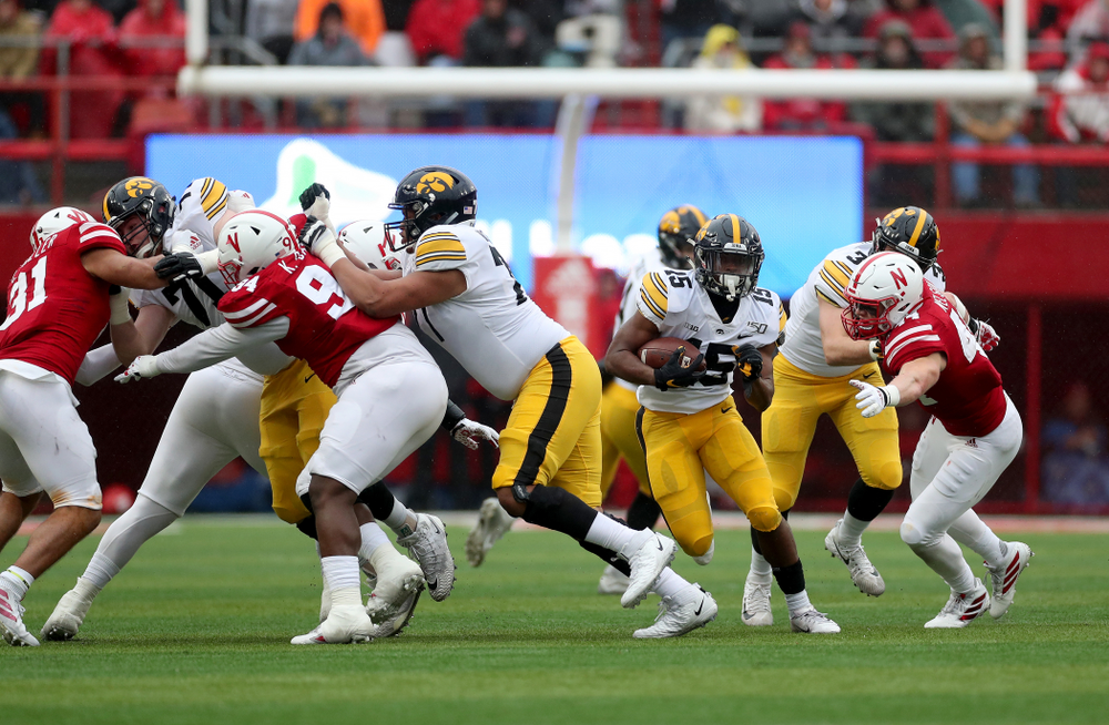 Iowa Hawkeyes running back Tyler Goodson (15) gets a block from offensive lineman Alaric Jackson (77) on his way to a touchdown against the Nebraska Cornhuskers Friday, November 29, 2019 at Memorial Stadium in Lincoln, Neb. (Brian Ray/hawkeyesports.com)