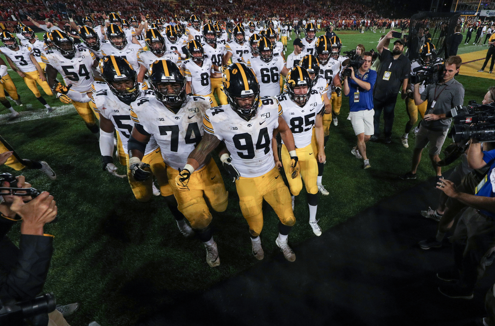 The Iowa Hawkeyes swarm to the Cy-Hawk trophy following their game against the Iowa State Cyclones Saturday, September 14, 2019 in Ames, Iowa. (Brian Ray/hawkeyesports.com)