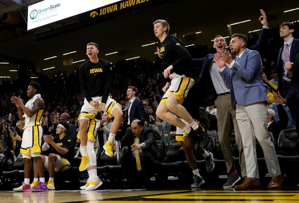 Iowa Hawkeyes guard Austin Ash (13), forward Michael Baer (0), forward Jack Nunge (2), and Jordan Bohannon celebrate on the bench against the Michigan Wolverines Friday, January 17, 2020 at Carver-Hawkeye Arena. (Brian Ray/hawkeyesports.com)