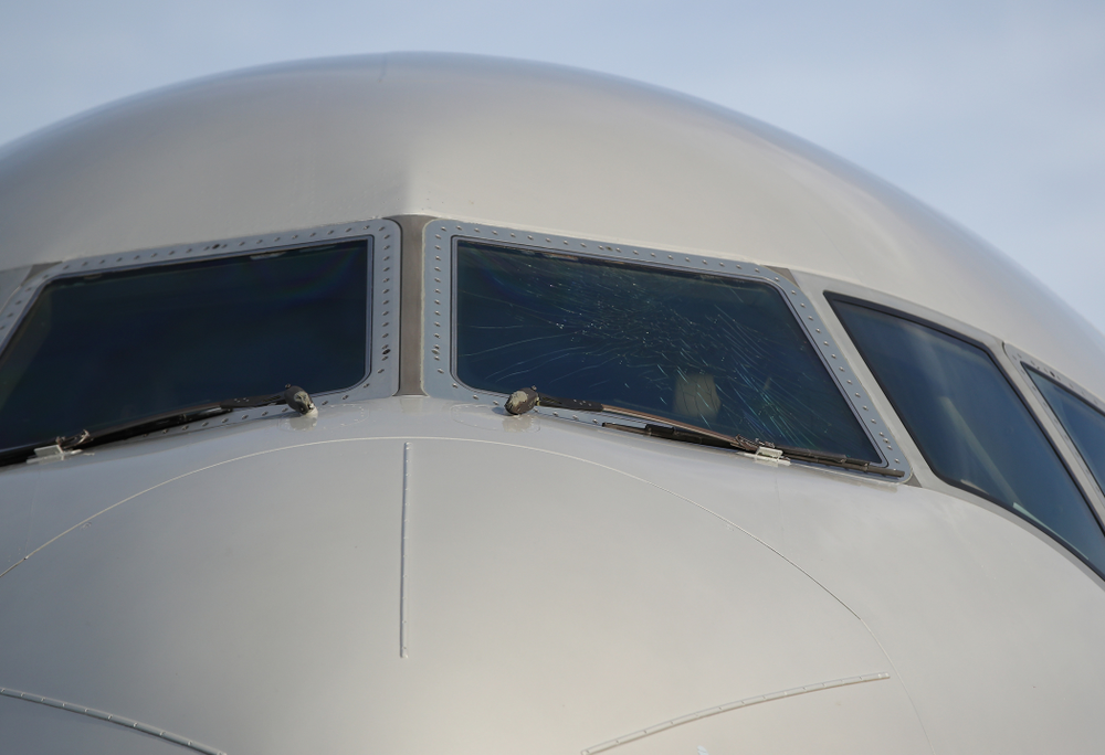 The outer layer of the front windscreen of the team plane is cracked Wednesday, December 26, 2018 as the Iowa Hawkeyes arrive in Tampa, Florida for the Outback Bowl. The flight crew scheduled to take the plane said the damage happened in flight and was due to fatigue from pressure changes in the air. (Brian Ray/hawkeyesports.com)