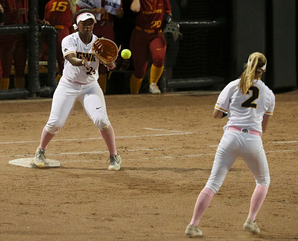 Iowa second baseman Aralee Bogar (2) throws to first baseman DoniRae Mayhew (24) for an out during the sixth inning of their game against Iowa State at Pearl Field in Iowa City on Tuesday, Apr. 9, 2019. (Stephen Mally/hawkeyesports.com)