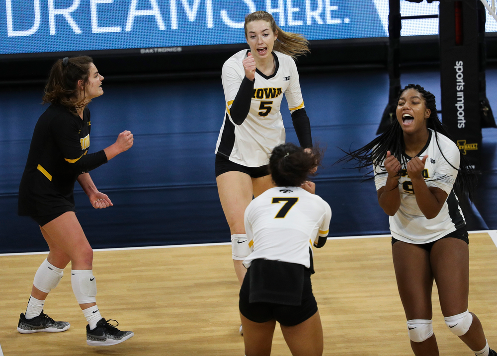 Iowa Hawkeyes defensive specialist Molly Kelly (1), Iowa Hawkeyes outside hitter Meghan Buzzerio (5) and Iowa Hawkeyes middle blocker Amiya Jones (9) celebrate after winning a point during a match against Maryland at Carver-Hawkeye Arena on November 23, 2018. (Tork Mason/hawkeyesports.com)