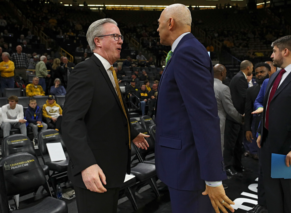 Iowa Hawkeyes head coach Fran McCaffery talks with DePaul head coach Dave Leitao before their game at Carver-Hawkeye Arena in Iowa City on Monday, Nov 11, 2019. (Stephen Mally/hawkeyesports.com)