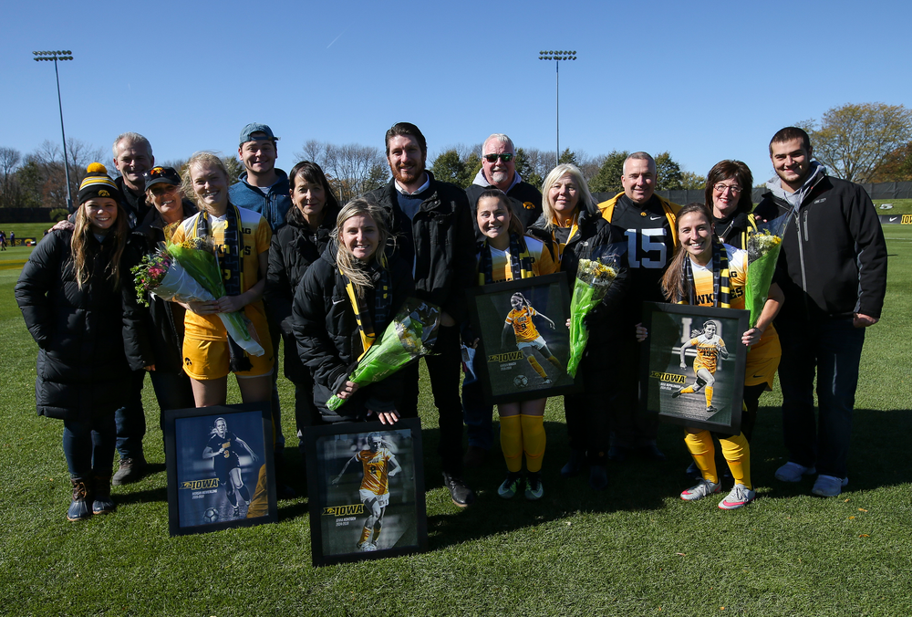 Senior members of the Iowa Hawkeyes soccer team pose for a photo with their families during Senior Day ceremonies before a game against Northwestern at the Iowa Soccer Complex on October 21, 2018. (Tork Mason/hawkeyesports.com)