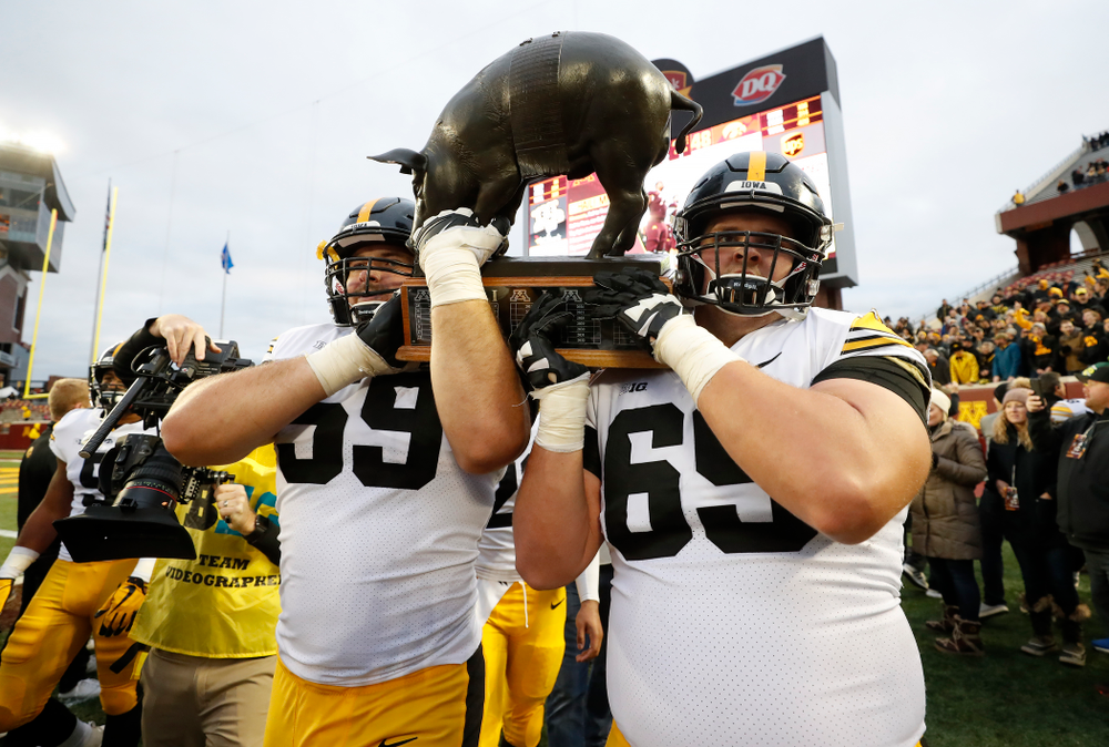The Iowa Hawkeyes celebrate with the Floyd of Rosedale trophy following their win over the Minnesota Golden Gophers Saturday, October 6, 2018 at TCF Bank Stadium. (Brian Ray/hawkeyesports.com)