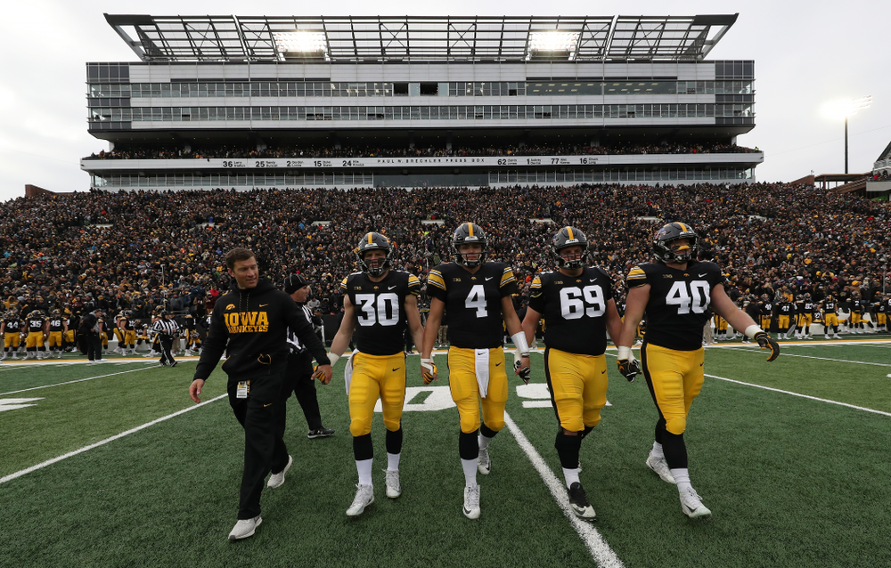 Honorary Captain Jason Baker walks to mid-field with captains Jake Gervase, Nate Stanley, Keegan Render, and Parker Hesse for the coin toss against the Northwestern Wildcats Saturday, November 10, 2018 at Kinnick Stadium. (Brian Ray/hawkeyesports.com)