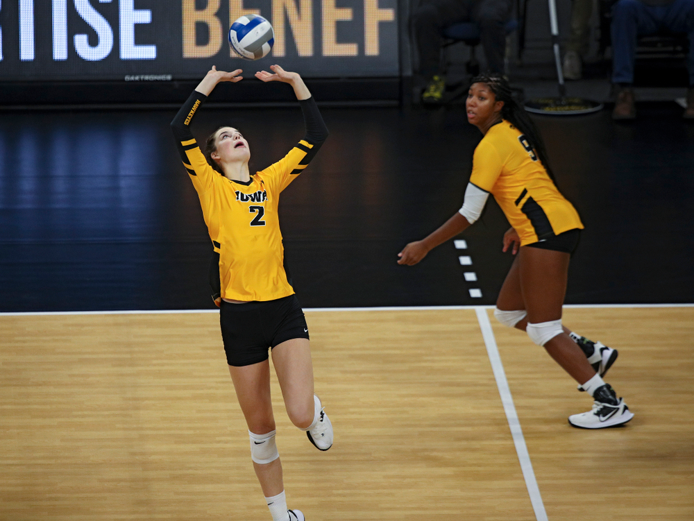 Iowa’s Courtney Buzzerio (2) sets the ball for Amiya Jones (9) who gets a kill during the second set of their match against Illinois at Carver-Hawkeye Arena in Iowa City on Wednesday, Nov 6, 2019. (Stephen Mally/hawkeyesports.com)