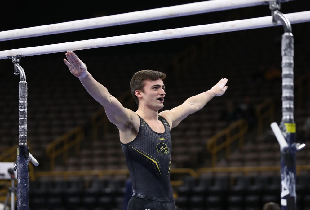 Iowa's Mitch Mandozzi competes on the parallel bars against the Ohio State Buckeyes Saturday, March 16, 2019 at Carver-Hawkeye Arena. (Brian Ray/hawkeyesports.com)
