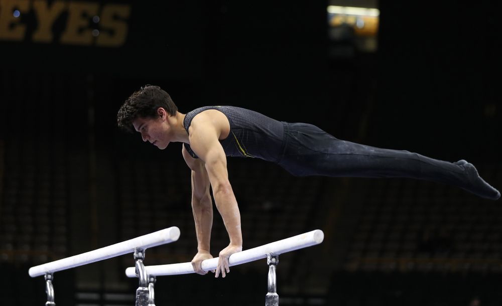 Iowa's Evan Davis competes on the parallel bars against the Ohio State Buckeyes Saturday, March 16, 2019 at Carver-Hawkeye Arena. (Brian Ray/hawkeyesports.com)