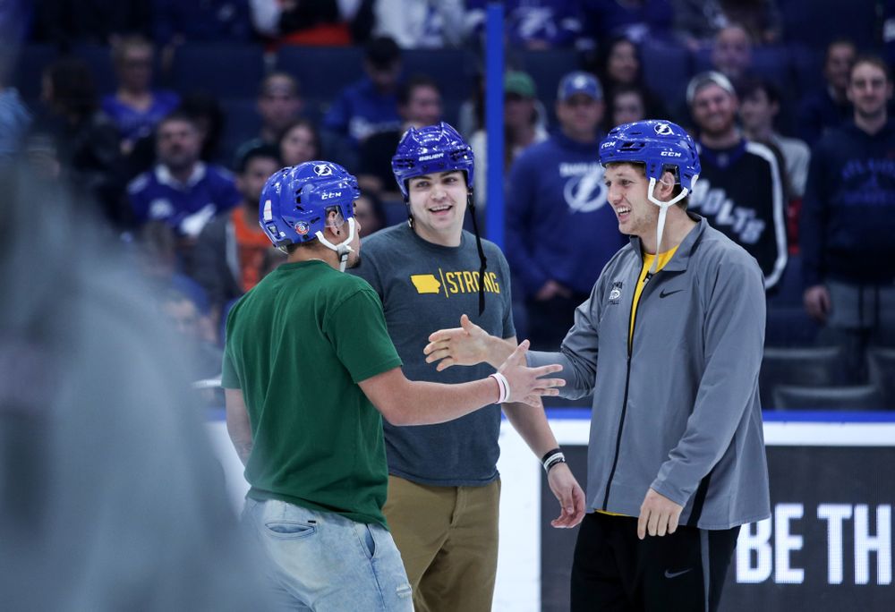 Iowa Hawkeyes tight end T.J. Hockenson (38), quarterback Nate Stanley (4), and defensive back Amani Hooker (27) following an on ice contest against Mississippi State during the first intermission of the Tampa Bay Lightning game Thursday, December 27, 2018 at Amalie Arena. (Brian Ray/hawkeyesports.com)