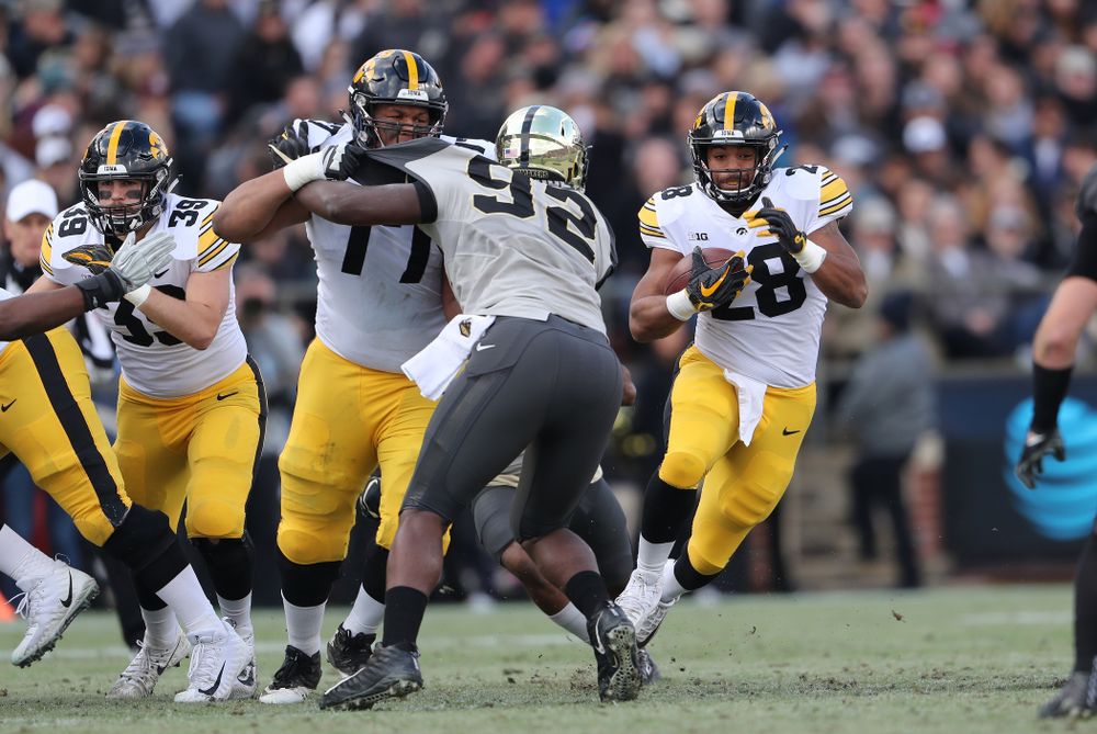 Iowa Hawkeyes running back Toren Young (28) and offensive lineman Alaric Jackson (77) against the Purdue Boilermakers Saturday, November 3, 2018 Ross Ade Stadium in West Lafayette, Ind. (Brian Ray/hawkeyesports.com)
