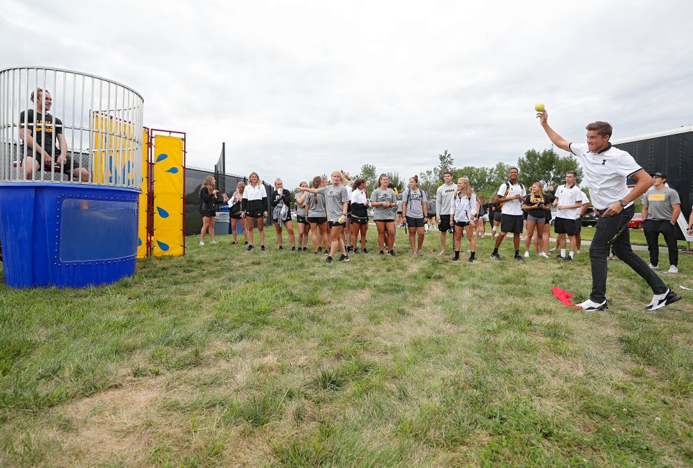 Iowa Men’s Tennis’ Joe Tyler throws to sink Women’s Tennis program coordinator Daniel Leitner in the dunk tank during the Student-Athlete Kickoff outside the Karro Athletics Hall of Fame Building in Iowa City on Sunday, Aug 25, 2019. (Stephen Mally/hawkeyesports.com)