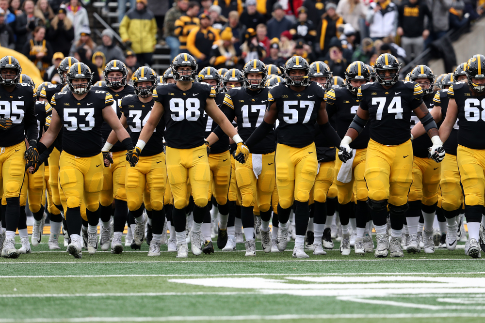 The Iowa Hawkeyes swarm onto the field before their game against the Nebraska Cornhuskers Friday, November 23, 2018 at Kinnick Stadium. (Brian Ray/hawkeyesports.com)