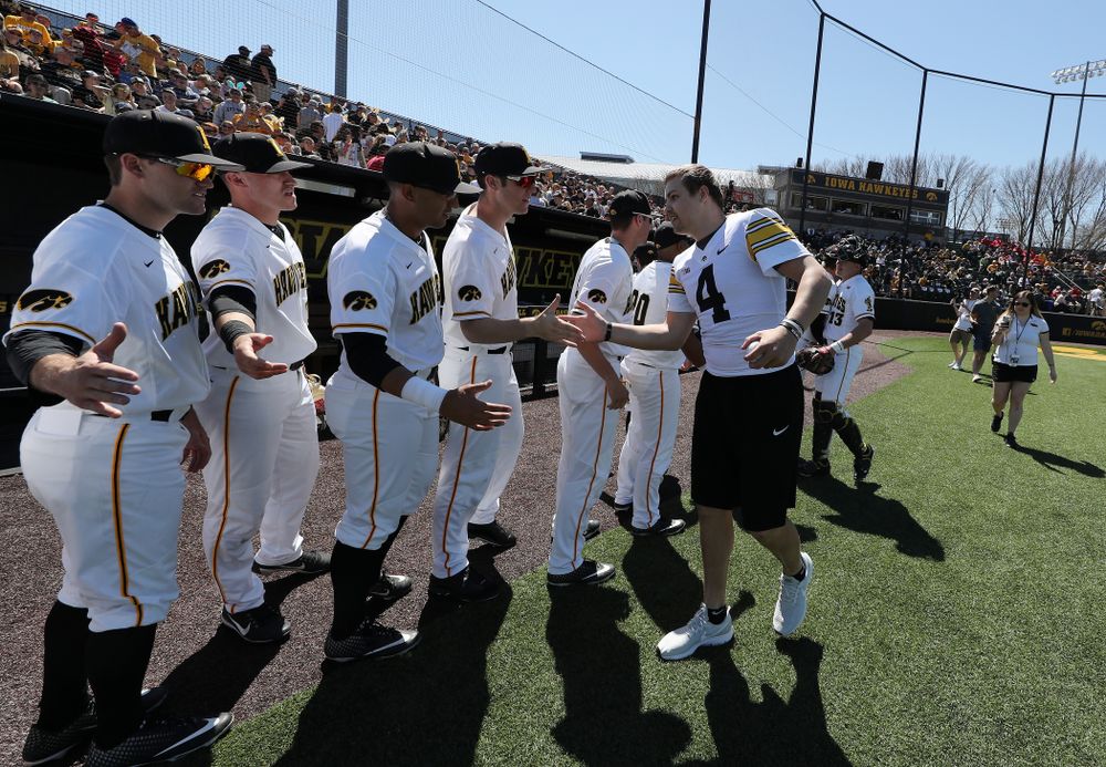 Iowa Hawkeyes quarterback Nate Stanley (4) throws out a first pitch against the Nebraska Cornhuskers Saturday, April 20, 2019 at Duane Banks Field. (Brian Ray/hawkeyesports.com)