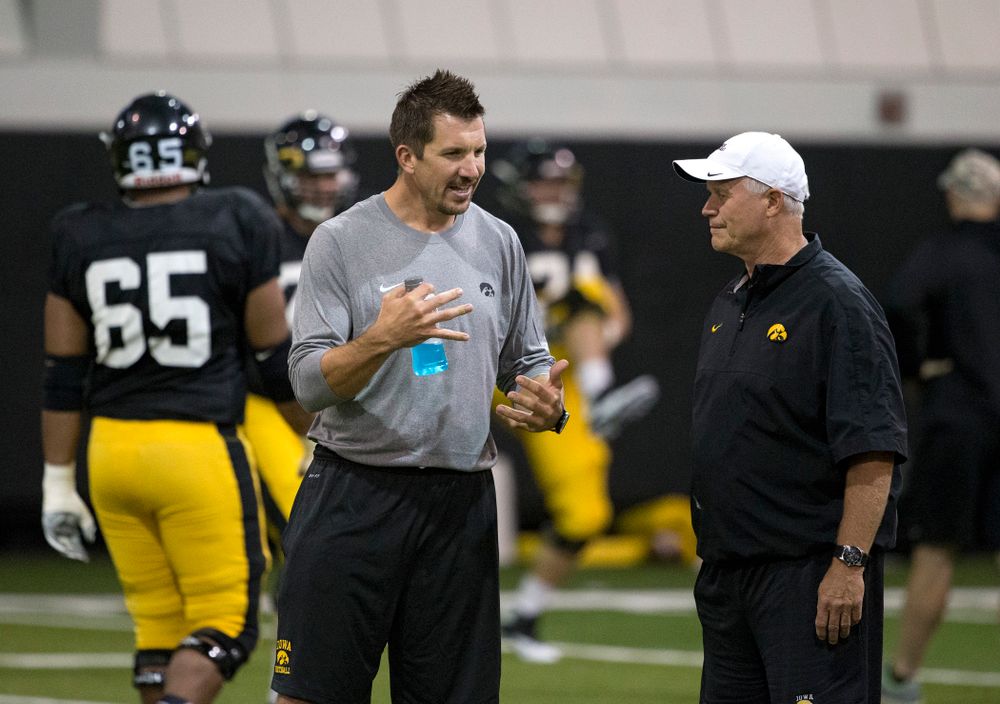 Former Hawkeye All-American tight end and 11 year NFL veteran Dallas Clark talks with defensive line coach Reese Morgan during the 19th practice of fall camp Wednesday, Aug. 19, 2015 in Iowa City. (Brian Ray/hawkeyesports.com)