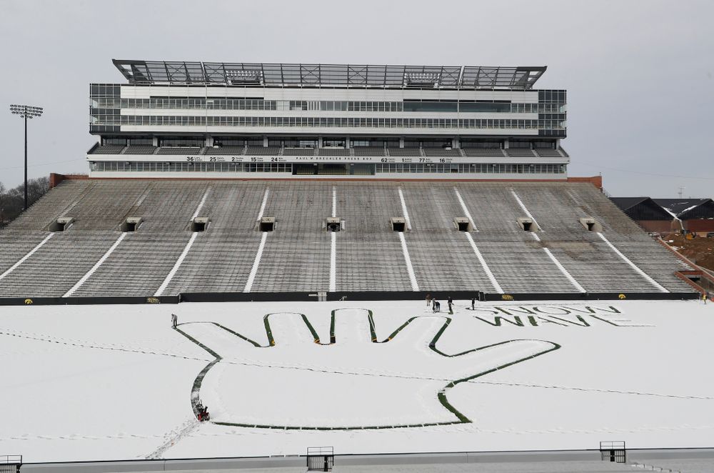 Members of the Iowa Athletics Turf Management staff create the #SnowWave for kids in the Stead Family Children's Hospital Thursday, February