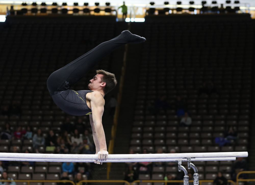 Iowa's Mitch Mandozzi competes on the parallel bars against the Ohio State Buckeyes Saturday, March 16, 2019 at Carver-Hawkeye Arena. (Brian Ray/hawkeyesports.com)