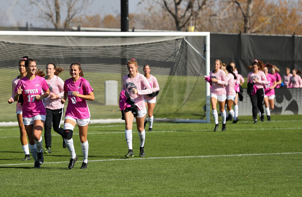 Iowa defender Hannah Drkulec (17) and midfielder Isabella Blackman (6) lead the time onto the field before their match at the Iowa Soccer Complex in Iowa City on Sunday, Oct 27, 2019. (Stephen Mally/hawkeyesports.com)
