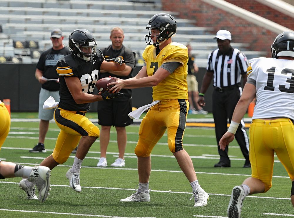 Iowa Hawkeyes wide receiver Nico Ragaini (89) takes a handoff from quarterback Spencer Petras (7) during Fall Camp Practice No. 8 at Kids Day at Kinnick Stadium in Iowa City on Saturday, Aug 10, 2019. (Stephen Mally/hawkeyesports.com)