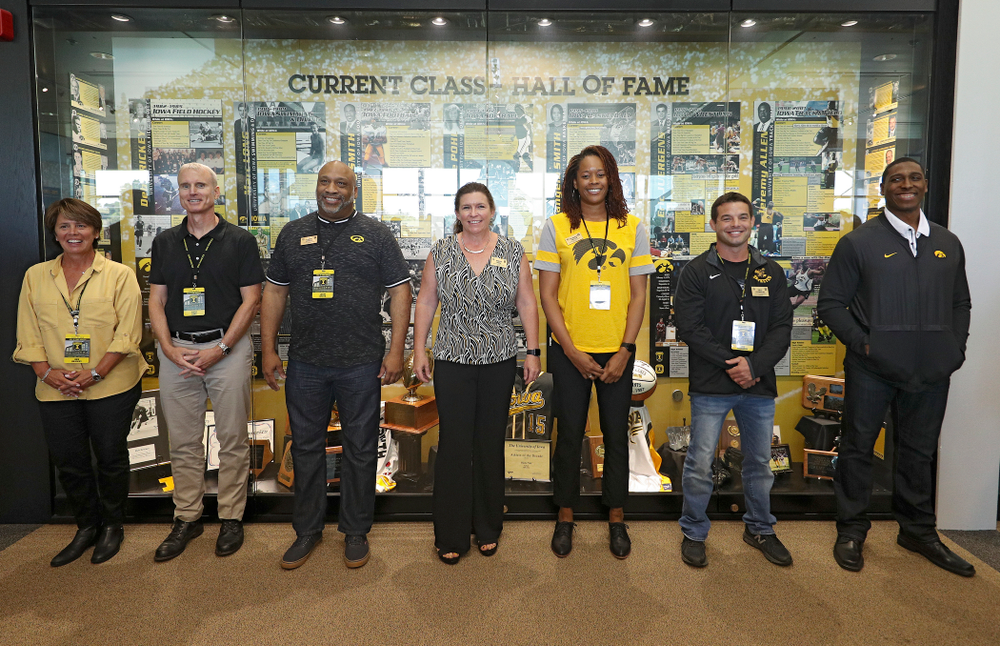 2019 University of Iowa Athletics Hall of Fame inductee Deb Brickey, Marc Long, Leroy Smith, Diane Pohl, Tangela Smith, Eric Juergens, and Jeremy Allen stand in front of their exhibit after it was unveiled at the University of Iowa Athletics Hall of Fame in Iowa City on Friday, Aug 30, 2019. (Stephen Mally/hawkeyesports.com)