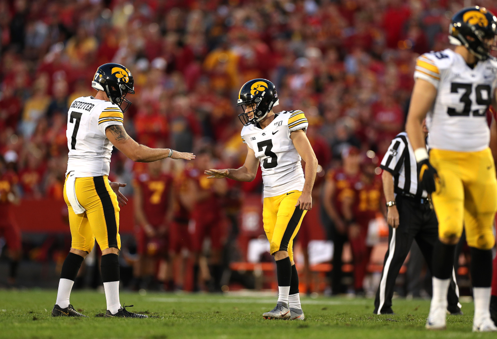 Iowa Hawkeyes place kicker Keith Duncan (3) plays rock, paper, scissors with punter Colten Rastetter (7) following a field goal against the Iowa State Cyclones Saturday, September 14, 2019 in Ames, Iowa. (Brian Ray/hawkeyesports.com)