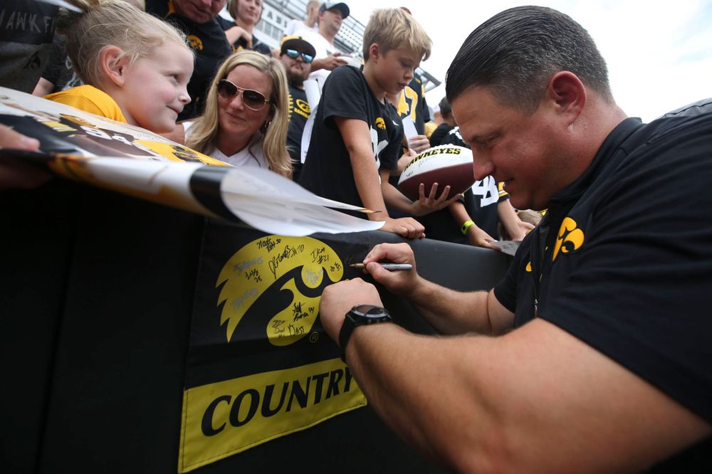 Iowa Hawkeyes offensive coordinator Brian Ferentz signs autographs during Kids Day at Kinnick Stadium on Saturday, August 10, 2019. (Lily Smith/hawkeyesports.com)