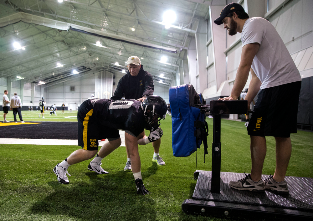 Iowa Hawkeyes defensive line coach Reese Morgan works with linebacker Parker Hesse (40) during their third bowl practice Friday, Dec. 19, 2014 in the indoor practice facility. (Brian Ray/hawkeyesports.com)