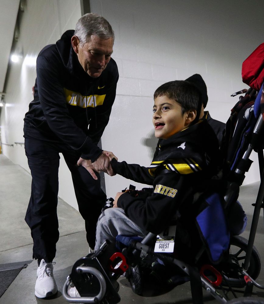 Iowa Hawkeyes head coach Kirk Ferentz shakes hands with Kid Captain Mason Gonzalez before a game against Northwestern at Kinnick Stadium on November 10, 2018. (Tork Mason/hawkeyesports.com)