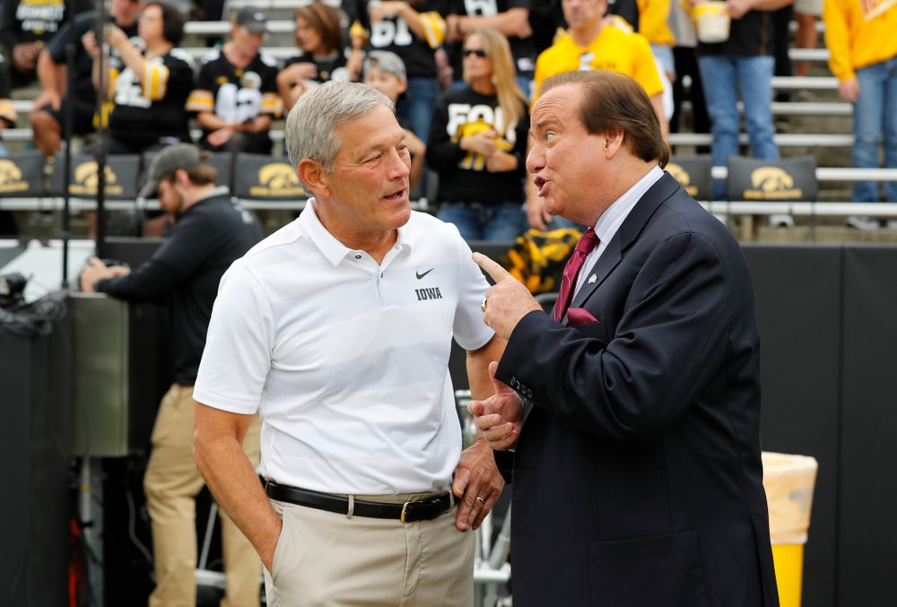 Iowa Hawkeyes head coach Kirk Ferentz talks with Tim Brando before their game against the Iowa State Cyclones Saturday, September 8, 2018 at Kinnick Stadium. (Brian Ray/hawkeyesports.com)
