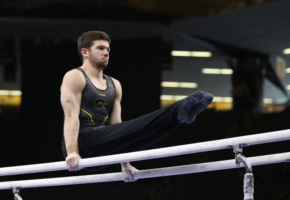 Iowa's Rogelio Vazquez competes on the parallel bars against the Ohio State Buckeyes Saturday, March 16, 2019 at Carver-Hawkeye Arena. (Brian Ray/hawkeyesports.com)