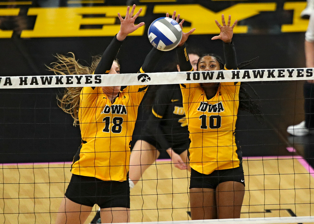 Iowa’s Hannah Clayton (18) and Griere Hughes (10) get a block during their match at Carver-Hawkeye Arena in Iowa City on Sunday, Oct 20, 2019. (Stephen Mally/hawkeyesports.com)