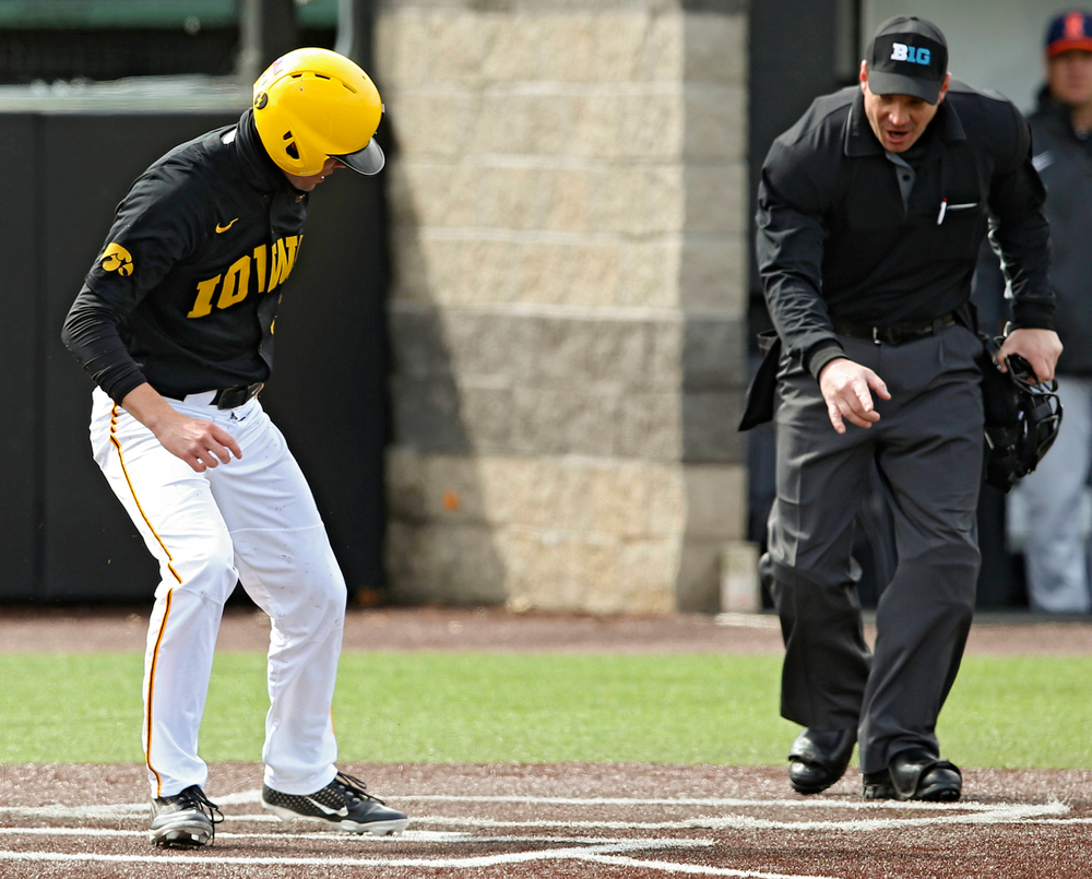 Iowa Hawkeyes right fielder Ben Norman (9) scores a run as the home plate umpire signals that the Illinois catcher blocked the plate during the second inning of their game against Illinois at Duane Banks Field in Iowa City on Saturday, Mar. 30, 2019. (Stephen Mally/hawkeyesports.com)