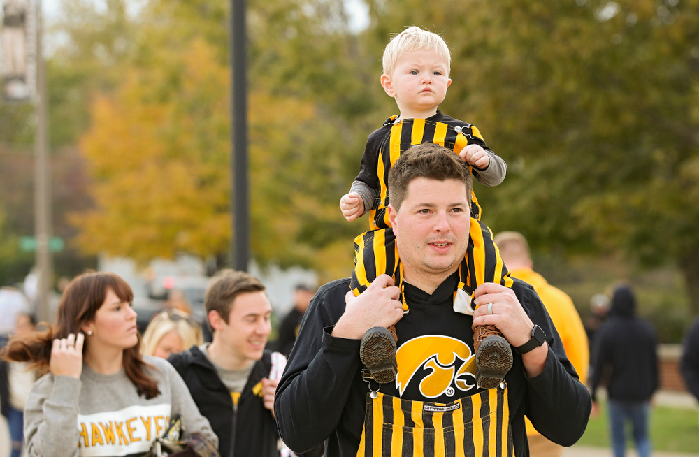 A young fan gets a ride as they walk along Melrose Avenue before the game at Kinnick Stadium in Iowa City on Saturday, Oct 19, 2019. (Stephen Mally/hawkeyesports.com)