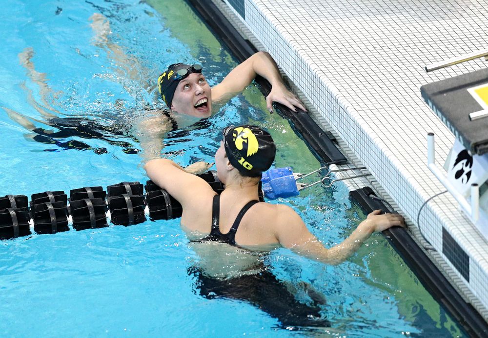 Iowa’s Allyssa Fluit (from top) and Hannah Burvill (lane 4) celebrate together after swimming the women’s 200 yard freestyle preliminary event during the 2020 Women’s Big Ten Swimming and Diving Championships at the Campus Recreation and Wellness Center in Iowa City on Friday, February 21, 2020. (Stephen Mally/hawkeyesports.com)