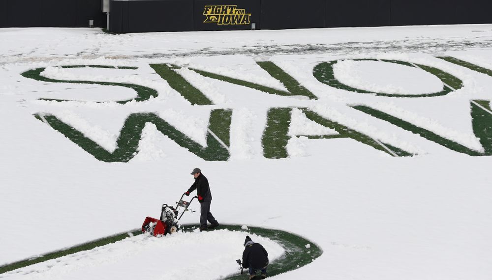 Members of the Iowa Athletics Turf Management staff create the #SnowWave for kids in the Stead Family Children's Hospital Thursday, February