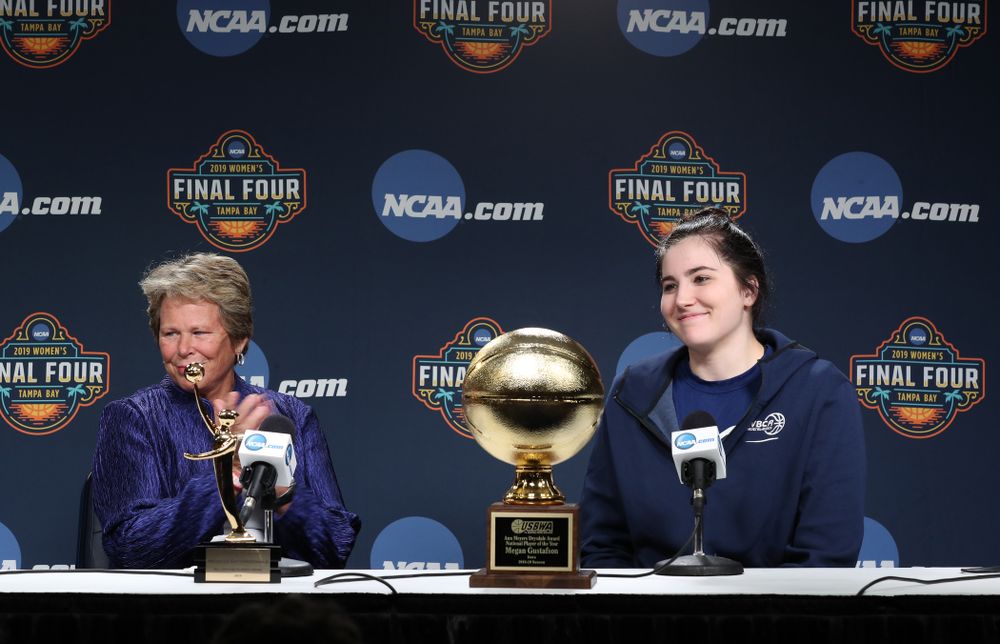 Iowa Hawkeyes forward Megan Gustafson (10) receives US Basketball Writers Association Ann Meyers Drysdale Player of the Year award from Ann Meyers Drysdale during a news conference Friday, April 5, 2019 at Amalie Arena in Tampa, FL. (Brian Ray/hawkeyesports.com)