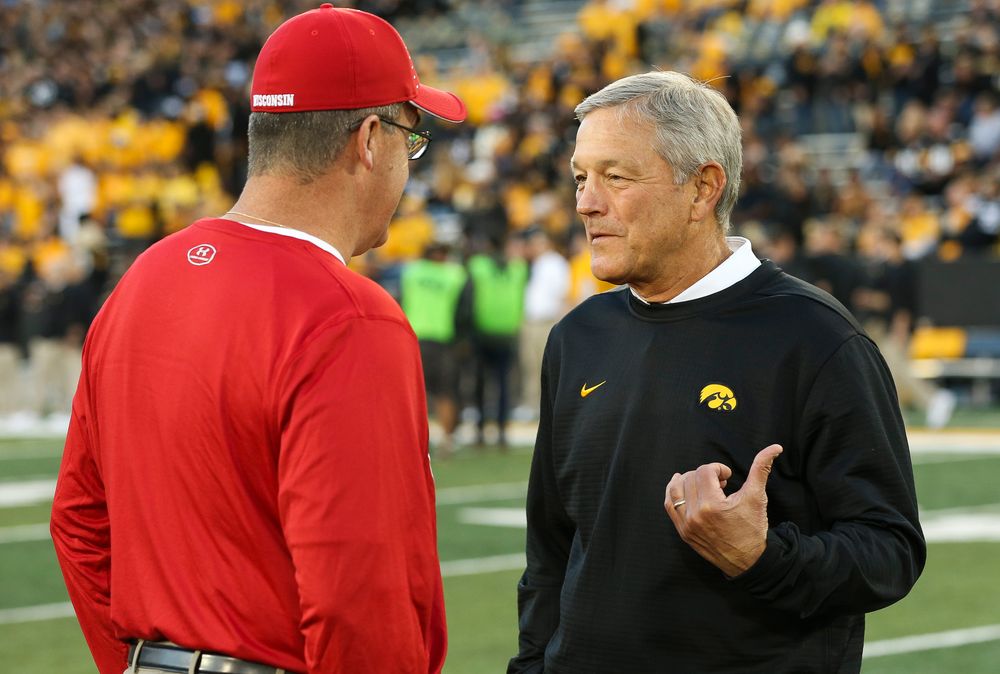 Iowa Hawkeyes head coach Kirk Ferentz meets with Wisconsin Badgers head coach Paul Chryst before a game against Wisconsin at Kinnick Stadium on September 22, 2018. (Tork Mason/hawkeyesports.com)