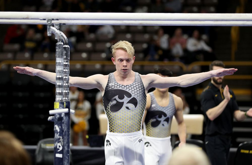 Iowa’s Nick Merryman competes on the parallel bars against UIC and Minnesota Saturday, February 1, 2020 at Carver-Hawkeye Arena. (Brian Ray/hawkeyesports.com)
