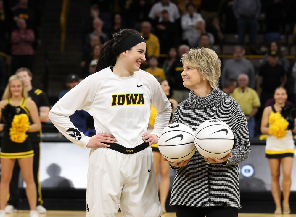 Iowa Hawkeyes forward Megan Gustafson (10) receives a pair of commemorative basketballs from head coach Lisa Bluder for becoming the school's all time rebounds leader and scoring leader before their gam eagainst the Nebraska Cornhuskers Thursday, January 3, 2019 at Carver-Hawkeye Arena. (Brian Ray/hawkeyesports.com)