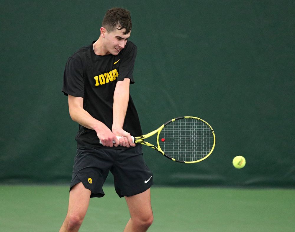 Iowa’s Matt Clegg hits a shot during their doubles match against Marquette at the Hawkeye Tennis and Recreation Complex in Iowa City on Saturday, January 25, 2020. (Stephen Mally/hawkeyesports.com)