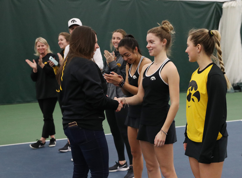Academic Student Services Associate Director Kara Park congratulates Cloe Ruette for earning a 3.0 GPA or better during the fall semester before their match against the Penn State Nittany Lions Sunday, February 24, 2019 at the Hawkeye Tennis and Recreation Complex. (Brian Ray/hawkeyesports.com)