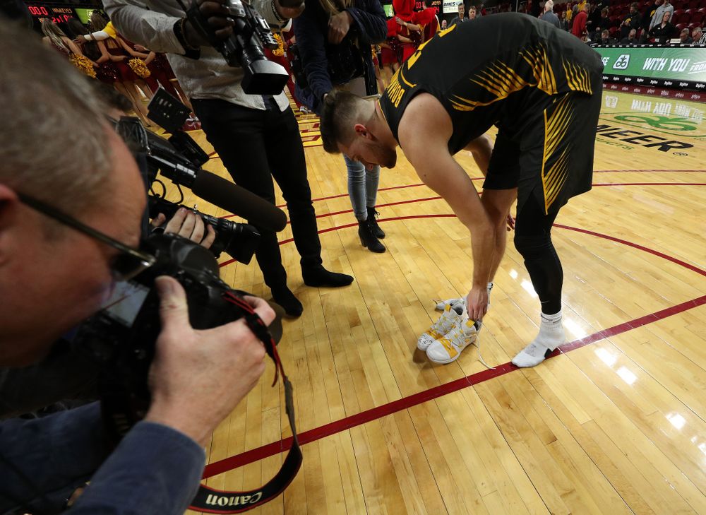 Iowa Hawkeyes guard Jordan Bohannon (3) writes a message on his shoes before leaving them on the court following their game against the Iowa State Cyclones Thursday, December 12, 2019 at Hilton Coliseum in Ames, Iowa(Brian Ray/hawkeyesports.com)