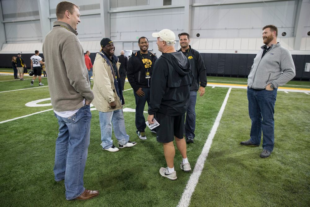 Iowa Hawkeyes defensive line coach Reese Morgan talks with members of the 2004 Big Ten Championship team following the team's walk through Friday, Sept. 12, 2014 in Iowa City. (Brian Ray/hawkeyesports.com)