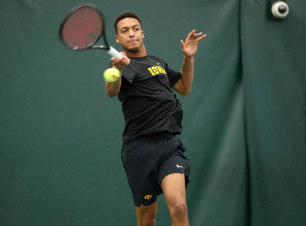 Iowa’s Oliver Okonkwo hits a shot during his match against Marquette at the Hawkeye Tennis and Recreation Complex in Iowa City on Saturday, January 25, 2020. (Stephen Mally/hawkeyesports.com)
