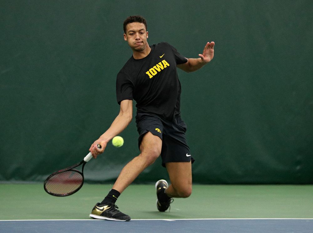 Iowa’s Oliver Okonkwo returns a shot during his singles match at the Hawkeye Tennis and Recreation Complex in Iowa City on Friday, March 6, 2020. (Stephen Mally/hawkeyesports.com)