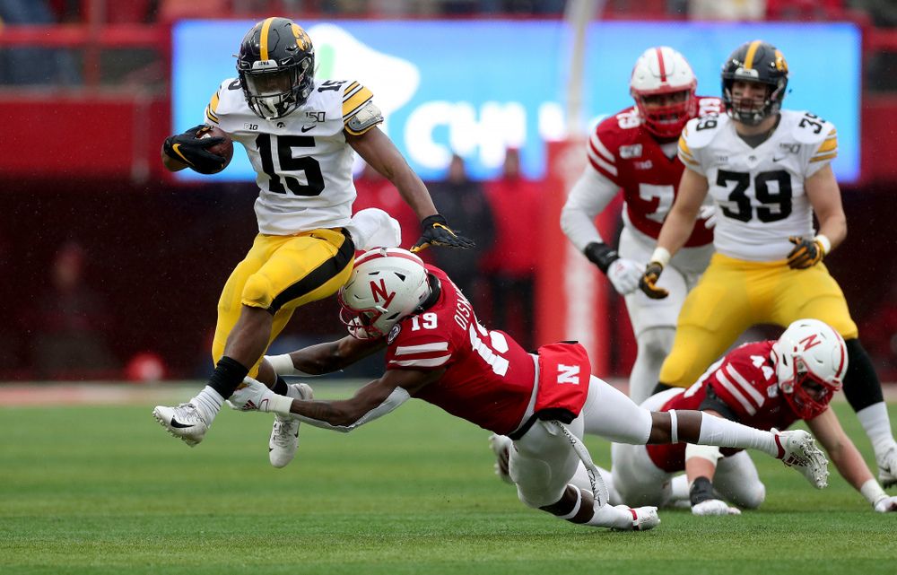 Iowa Hawkeyes running back Tyler Goodson (15) braces a tackle on his way to a touchdown against the Nebraska Cornhuskers Friday, November 29, 2019 at Memorial Stadium in Lincoln, Neb. (Brian Ray/hawkeyesports.com)