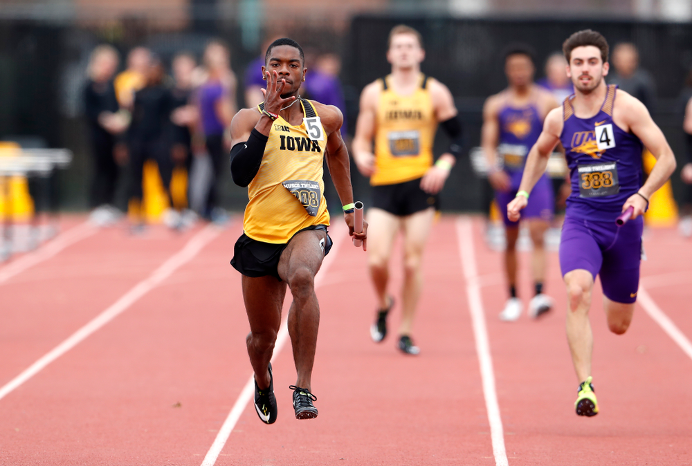 Iowa's Antonio Woodard runs the final leg of 4x100 during the 2018 MUSCO Twilight Invitational Thursday, April 12, 2018 at the Cretzmeyer T
