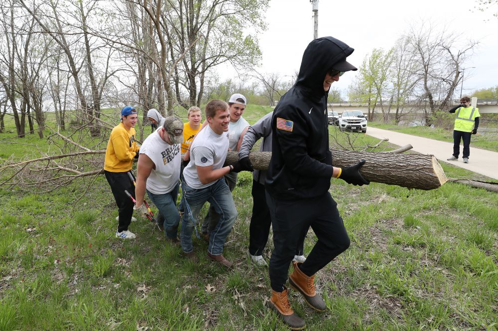 Members of the Hawkeye Football team volunteer with the Iowa City Public Works department along the Iowa River during the annual Iowa Athletics Day of Caring Sunday, April 28, 2019 in Iowa City. (Brian Ray/hawkeyesports.com)