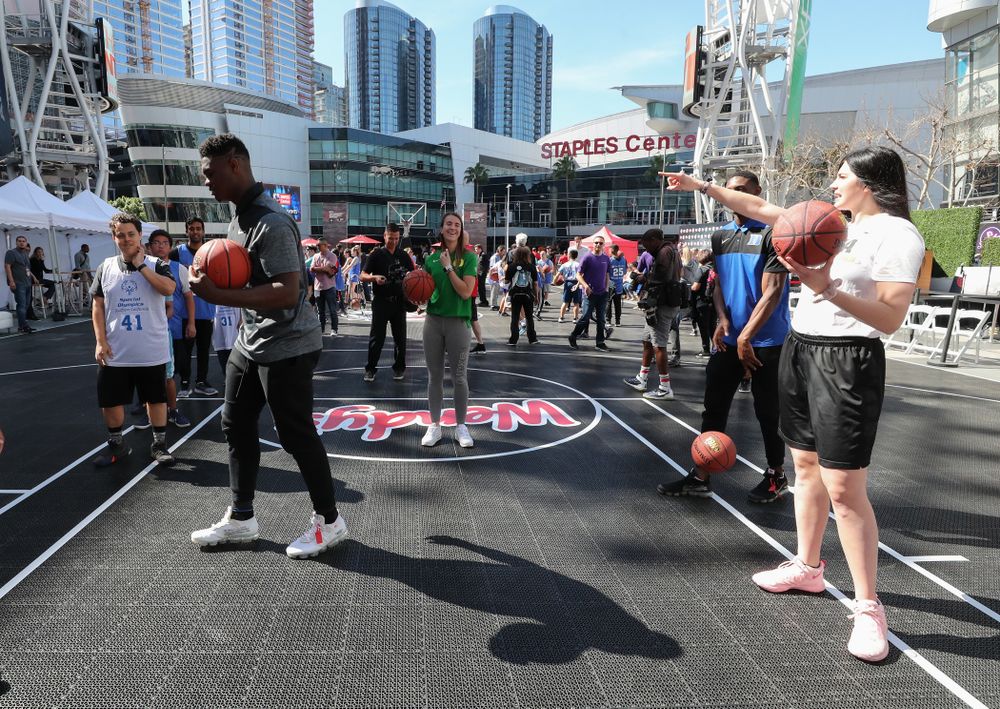 Iowa Hawkeyes forward Megan Gustafson (10) runs a drill with Zion Williamson during a Special Olympics event Friday, April 12, 2019 as part of the ESPN College Basketball Awards in the XBOX Plaza at LA Live. (Brian Ray/hawkeyesports.com)