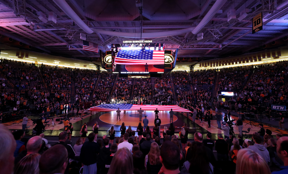 Members of the military spread out a large flag during the National Anthem before the Iowa Hawkeyes meet against Minnesota Saturday, February 15, 2020 at Carver-Hawkeye Arena. (Brian Ray/hawkeyesports.com)